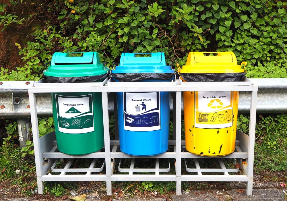 Three color trash can compostable, general and recyclable.  Environment. Space for text